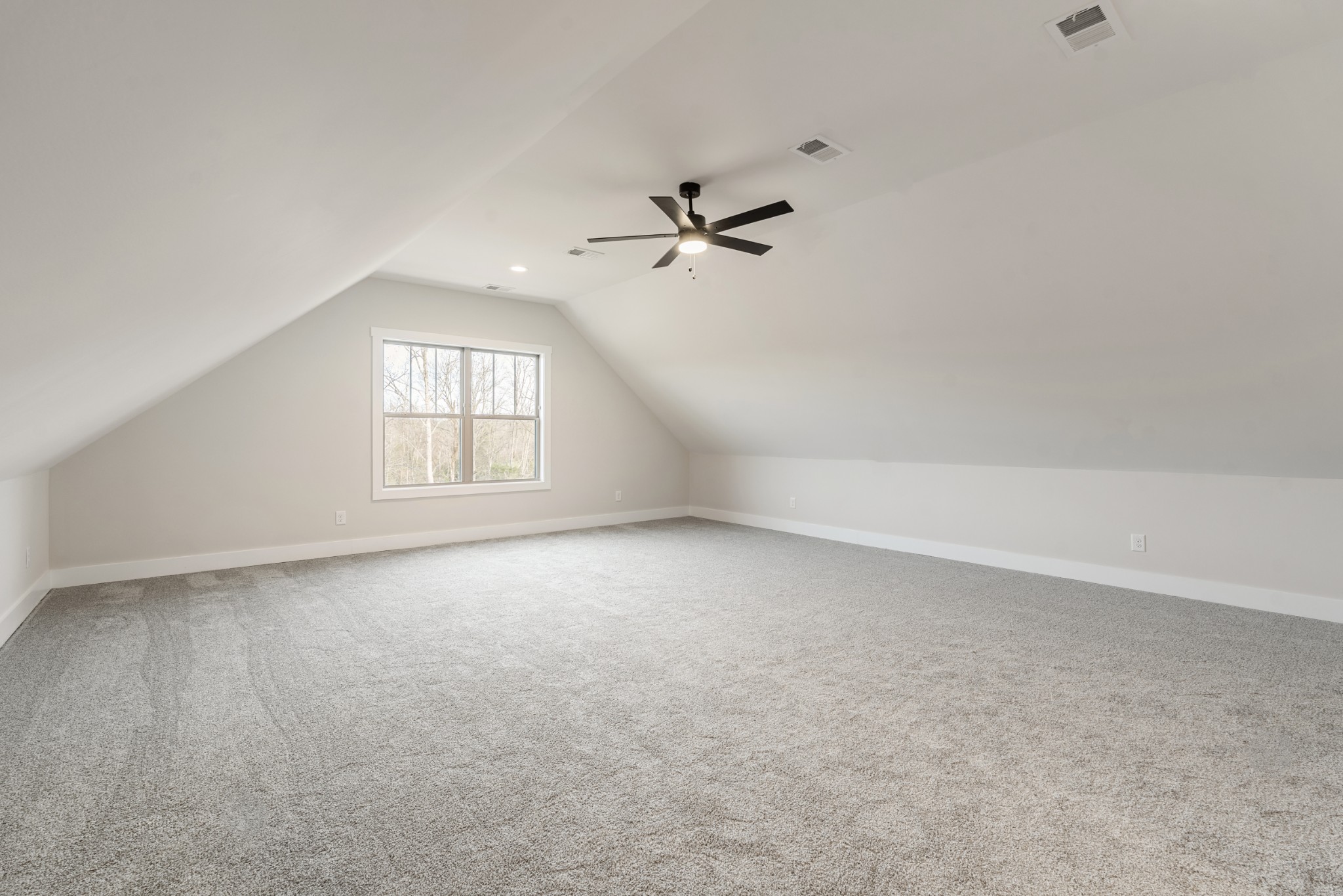 8078 Gideon Road Greenbrier, TN 37073 - Photo 22 of 26 an empty room with chandelier fan and windows