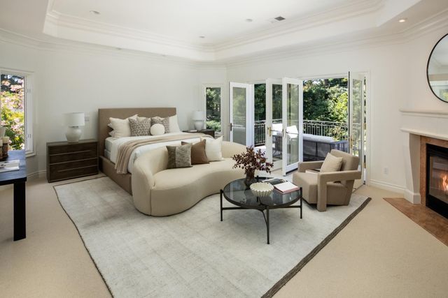 a bedroom with furniture and a fireplace