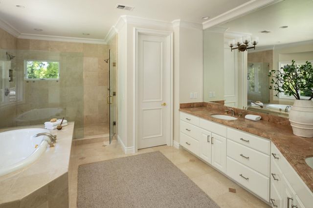 a spacious bathroom with a granite countertop tub sink and mirror