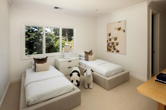 a bedroom with a bed and a large window