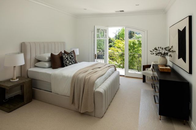 a room with a bed couch and a large window