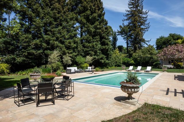 a view of a backyard with sitting area