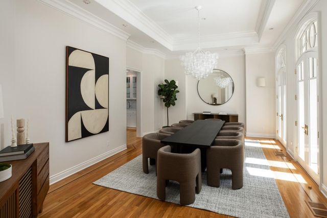 a living room with furniture a window and wooden floor
