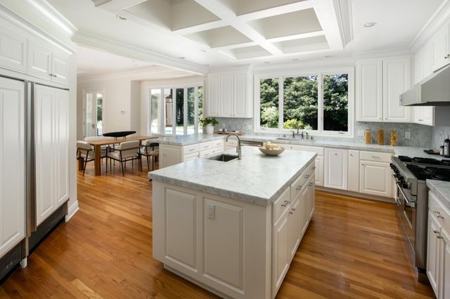 a kitchen with a sink stove and cabinets