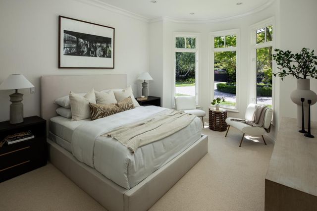 a bedroom with bed couch and window