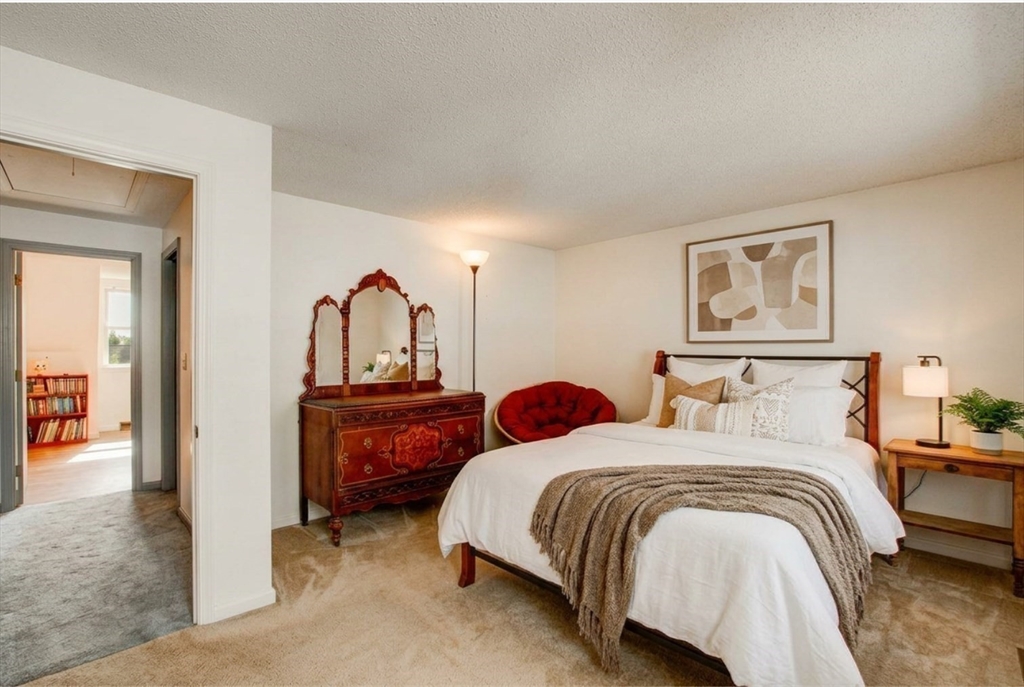 53 Century Way, Unit 53 Gardner, MA 01440 - Photo 18 of 22 a bedroom with a bed and a painting on the wall