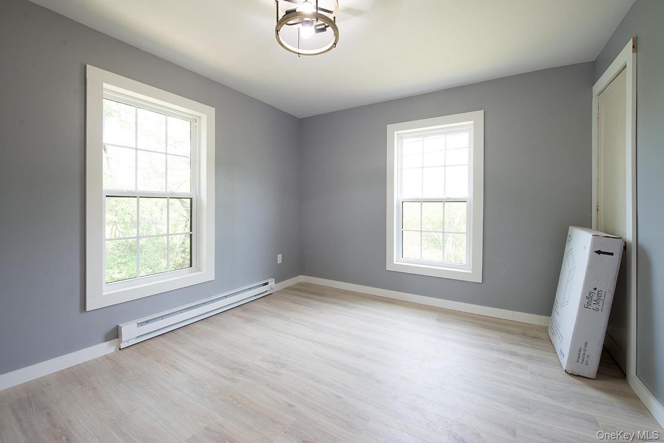 1132 Old Rte 17 Harris, NY 12742 - Photo 12 of 26 Empty room with a baseboard radiator and light wood-style floors
