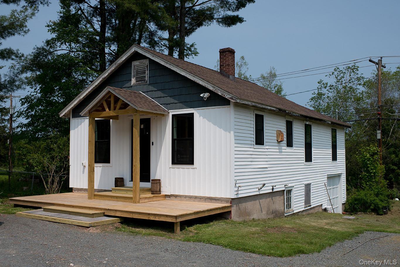 1132 Old Rte 17 Harris, NY 12742 - Photo 24 of 26 View of front of property with roof with shingles, a chimney, a deck, and board and batten siding