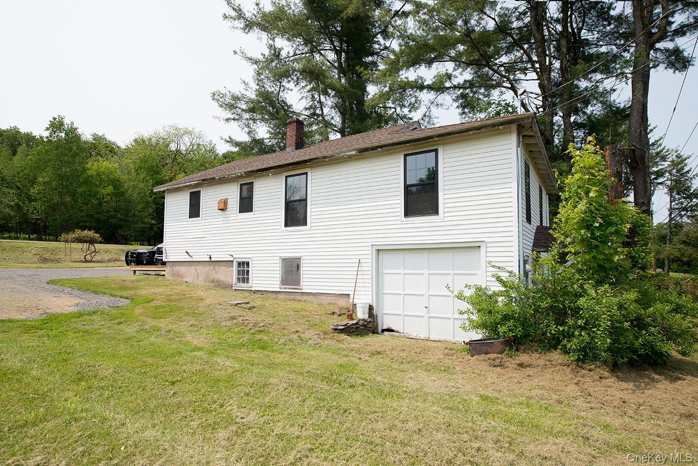 1132 Old Rte 17 Harris, NY 12742 - Photo 26 of 26 Back of property featuring a yard, a chimney, and an attached garage