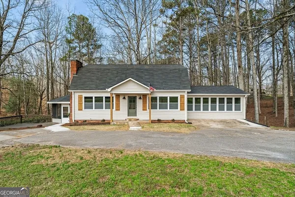 a front view of a house with a garden