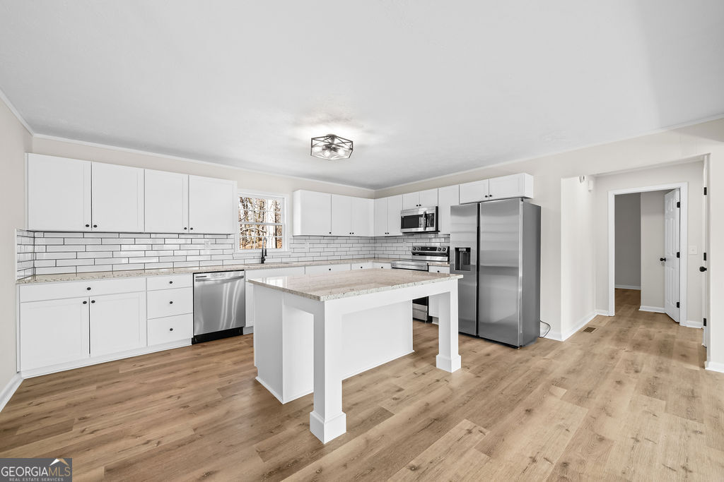 18 Holder Road Temple, GA 30179 - Photo 13 of 44 a kitchen with refrigerator cabinets and wooden floor