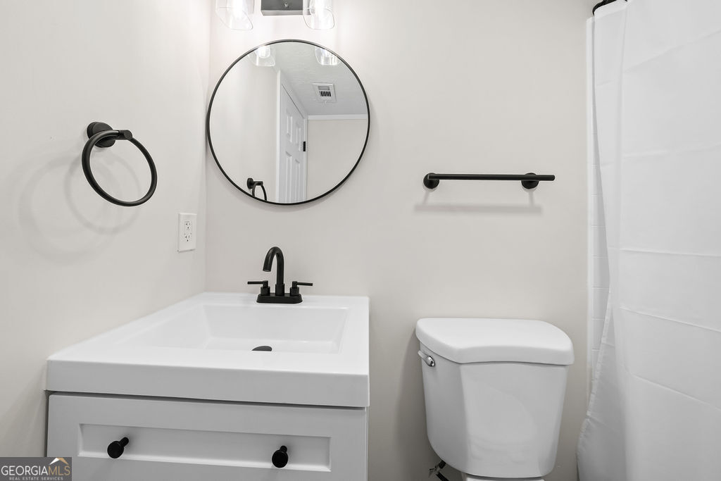 18 Holder Road Temple, GA 30179 - Photo 29 of 44 a bathroom with a sink mirror and toilet