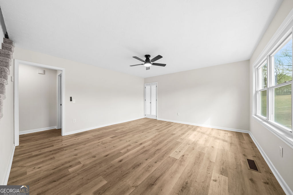 18 Holder Road Temple, GA 30179 - Photo 7 of 44 a view of empty room with wooden floor and fan