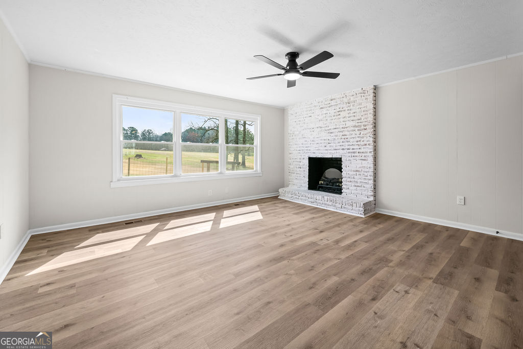 18 Holder Road Temple, GA 30179 - Photo 9 of 44 a view of an empty room with wooden floor fireplace and a window