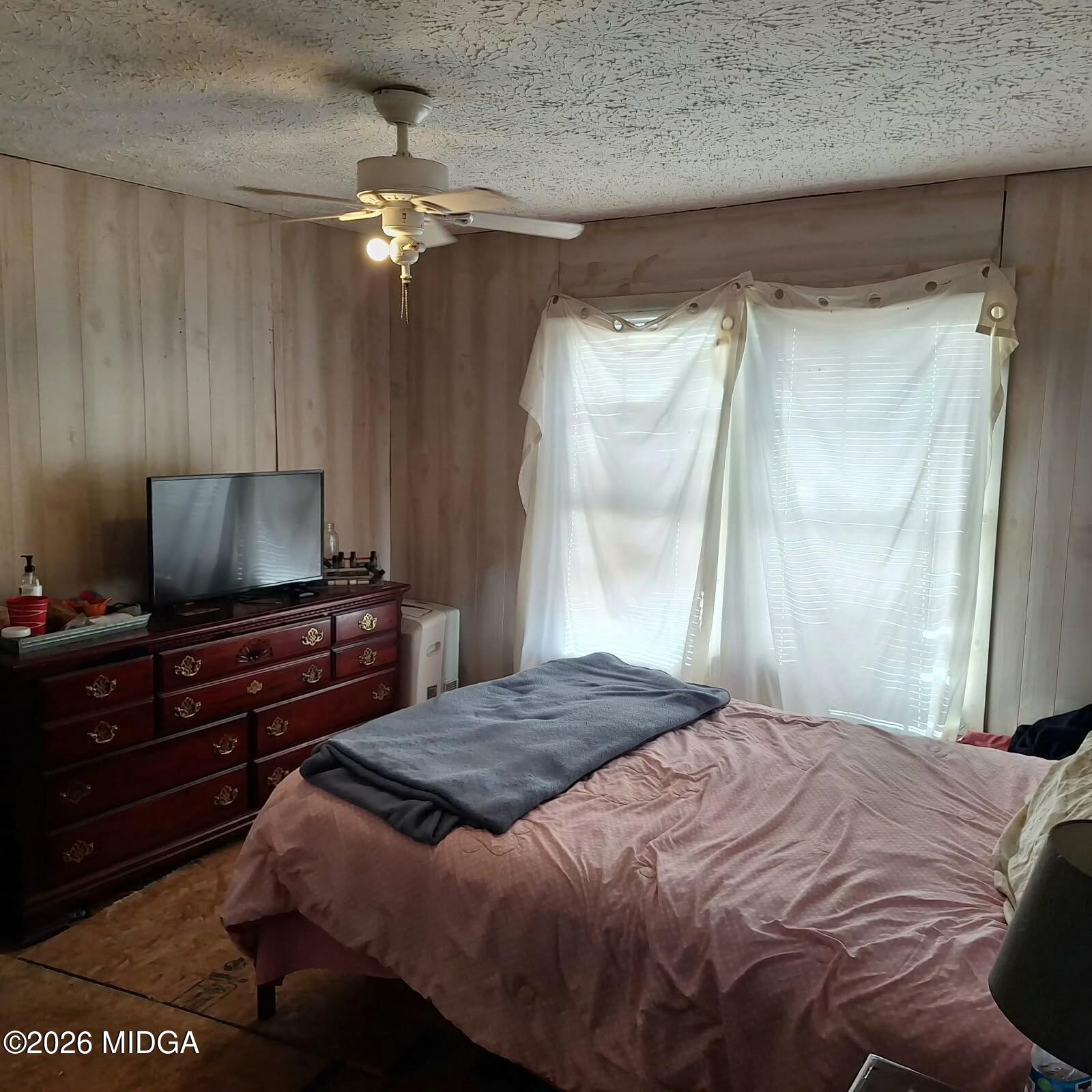 680 Natures Trail Forsyth, GA 31029 - Photo 8 of 14 a bedroom with a bed and a flat screen tv