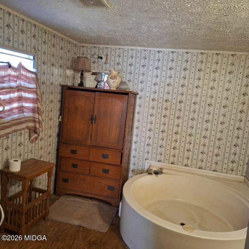 680 Natures Trail Forsyth, GA 31029 - Photo 9 of 14 a bathroom with a bathtub and shower