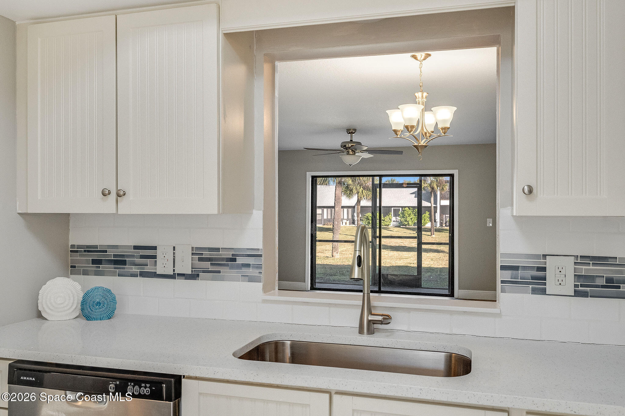 720 Palm Springs Circle Indian Harbour Beach, FL 32937 - Photo 11 of 57 a kitchen with a sink cabinets and window