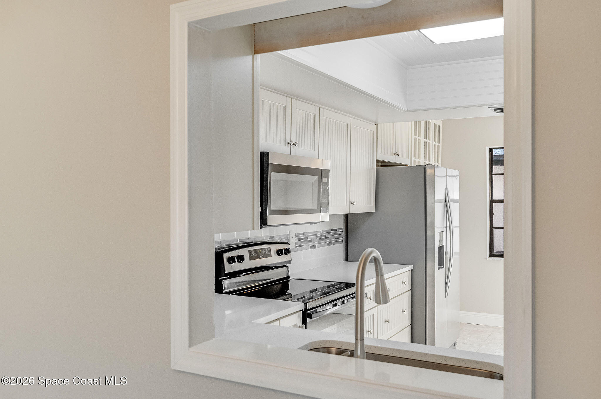 720 Palm Springs Circle Indian Harbour Beach, FL 32937 - Photo 12 of 57 a view of kitchen with wooden floor and electronic appliances
