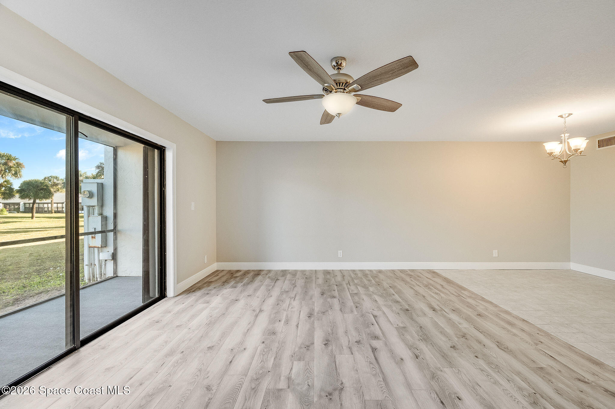 720 Palm Springs Circle Indian Harbour Beach, FL 32937 - Photo 15 of 57 wooden floor in an empty room with a window