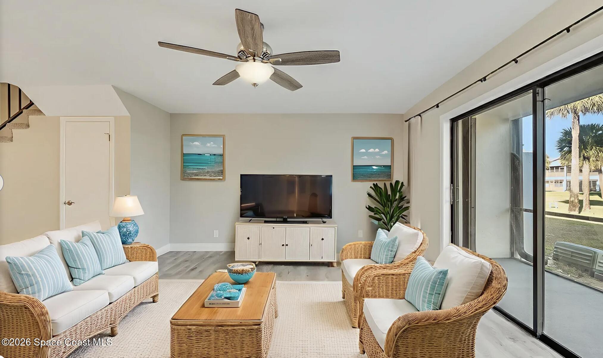 720 Palm Springs Circle Indian Harbour Beach, FL 32937 - Photo 20 of 57 a living room with furniture and a flat screen tv