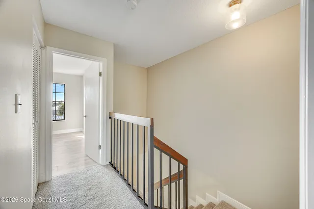 a view of empty room with wooden floor and ceiling fan