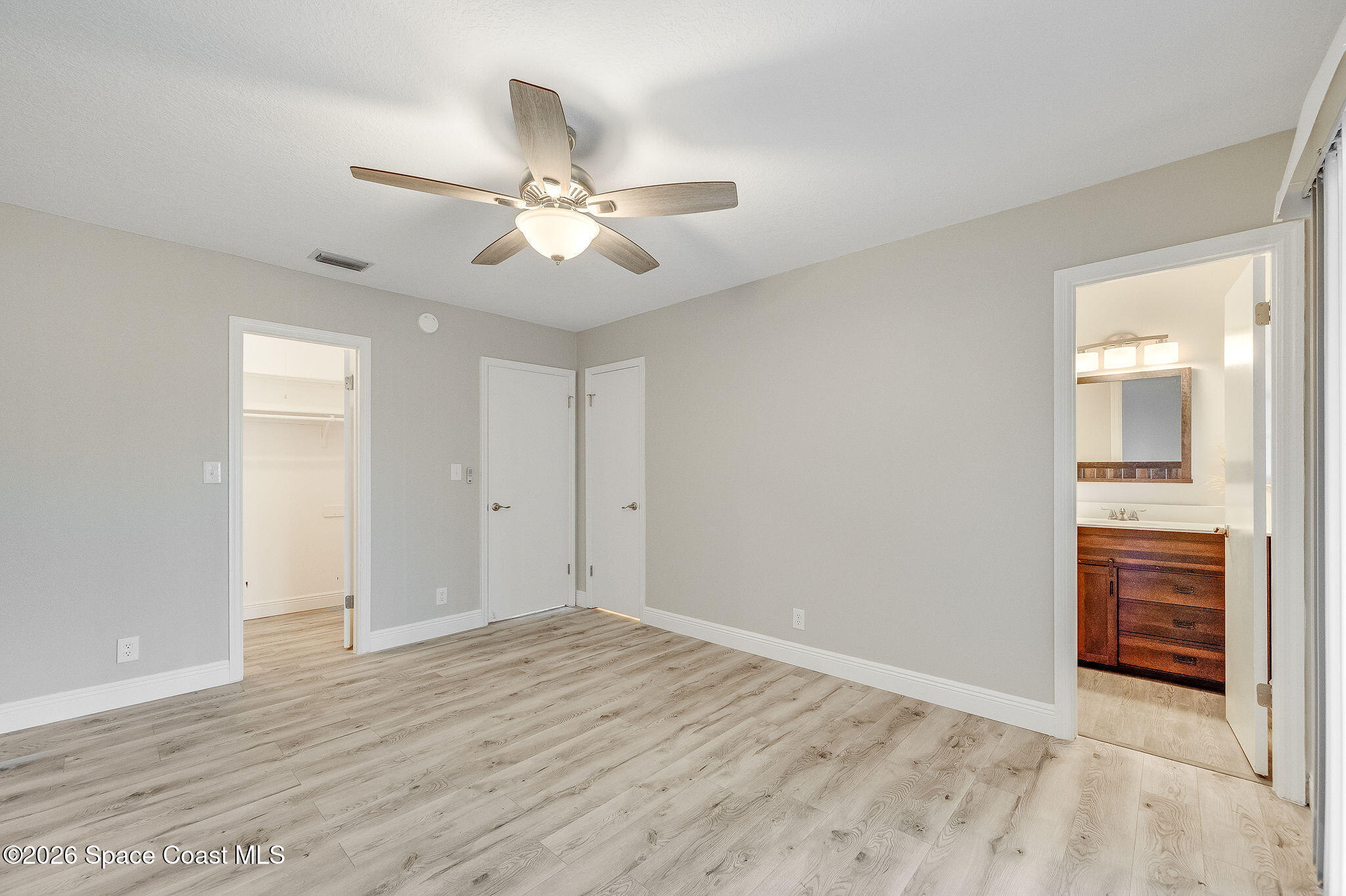 720 Palm Springs Circle Indian Harbour Beach, FL 32937 - Photo 26 of 57 a view of empty room with wooden floor and ceiling fan