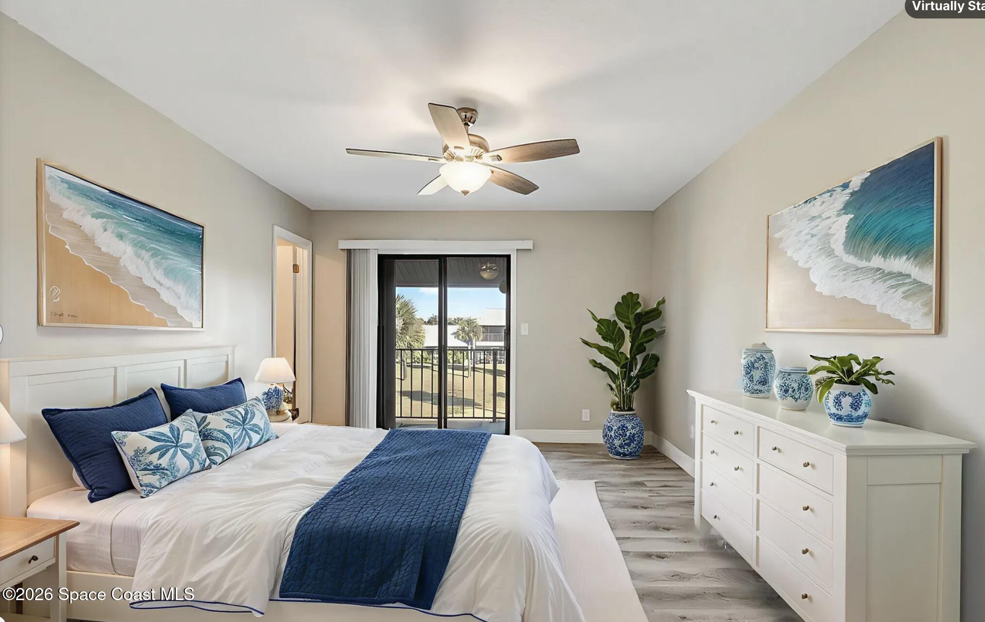 720 Palm Springs Circle Indian Harbour Beach, FL 32937 - Photo 27 of 57 a bedroom with a large bed and a chandelier