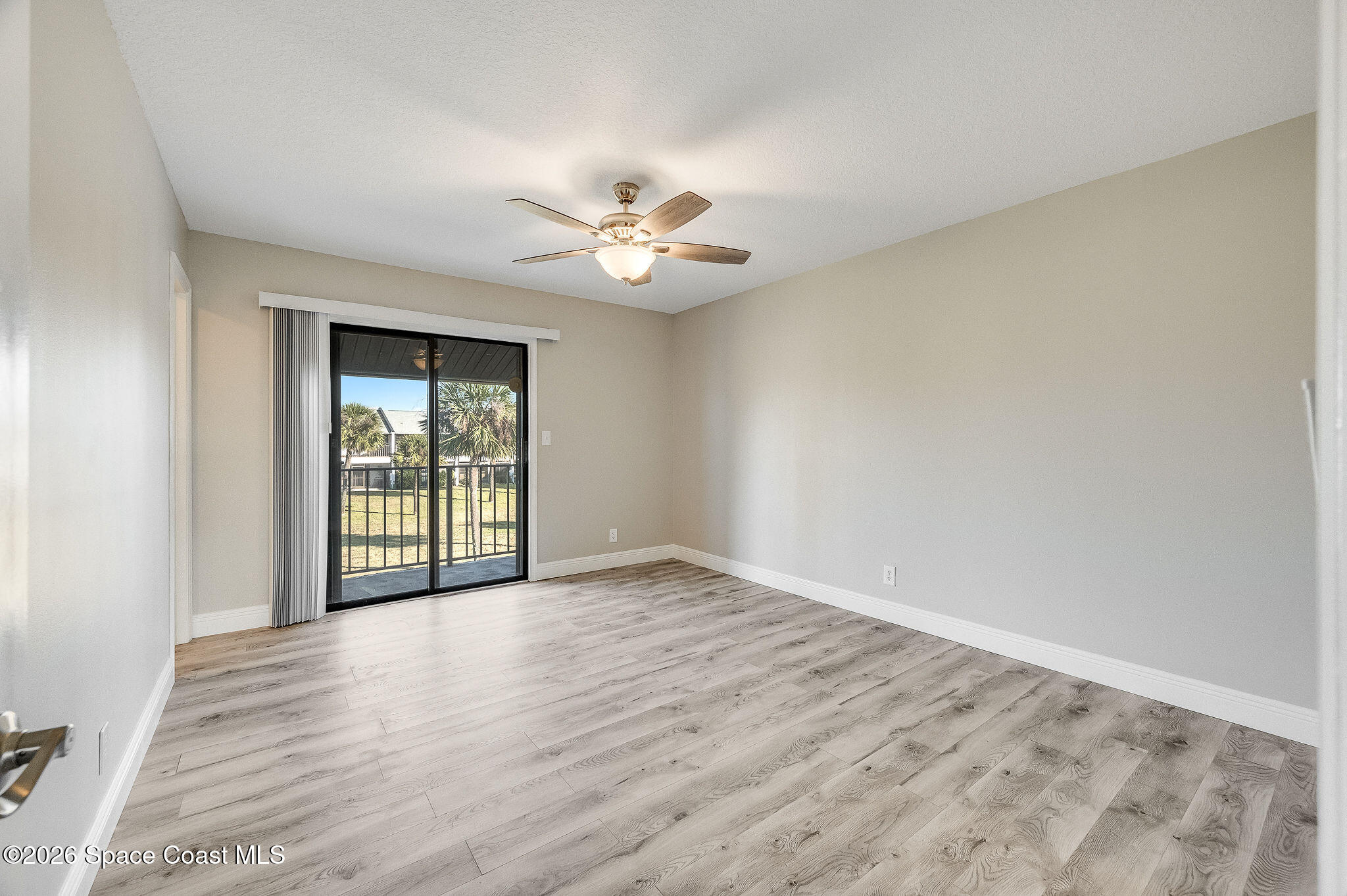 720 Palm Springs Circle Indian Harbour Beach, FL 32937 - Photo 28 of 57 wooden floor in an empty room with a window