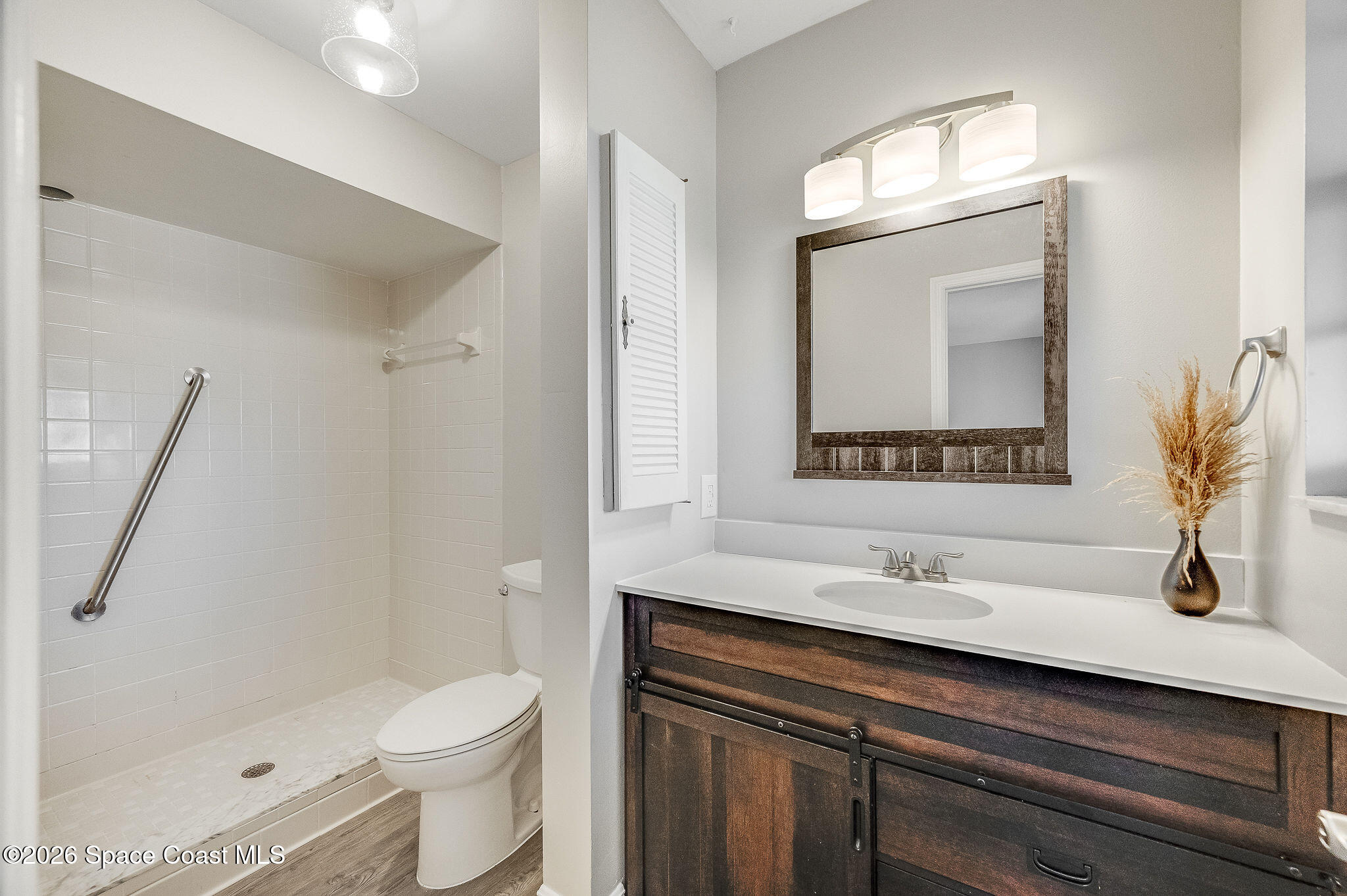 720 Palm Springs Circle Indian Harbour Beach, FL 32937 - Photo 31 of 57 a bathroom with a sink a toilet and shower