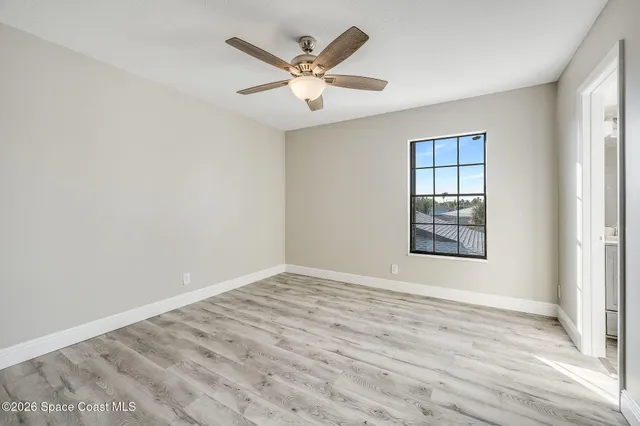 wooden floor in an empty room with a window