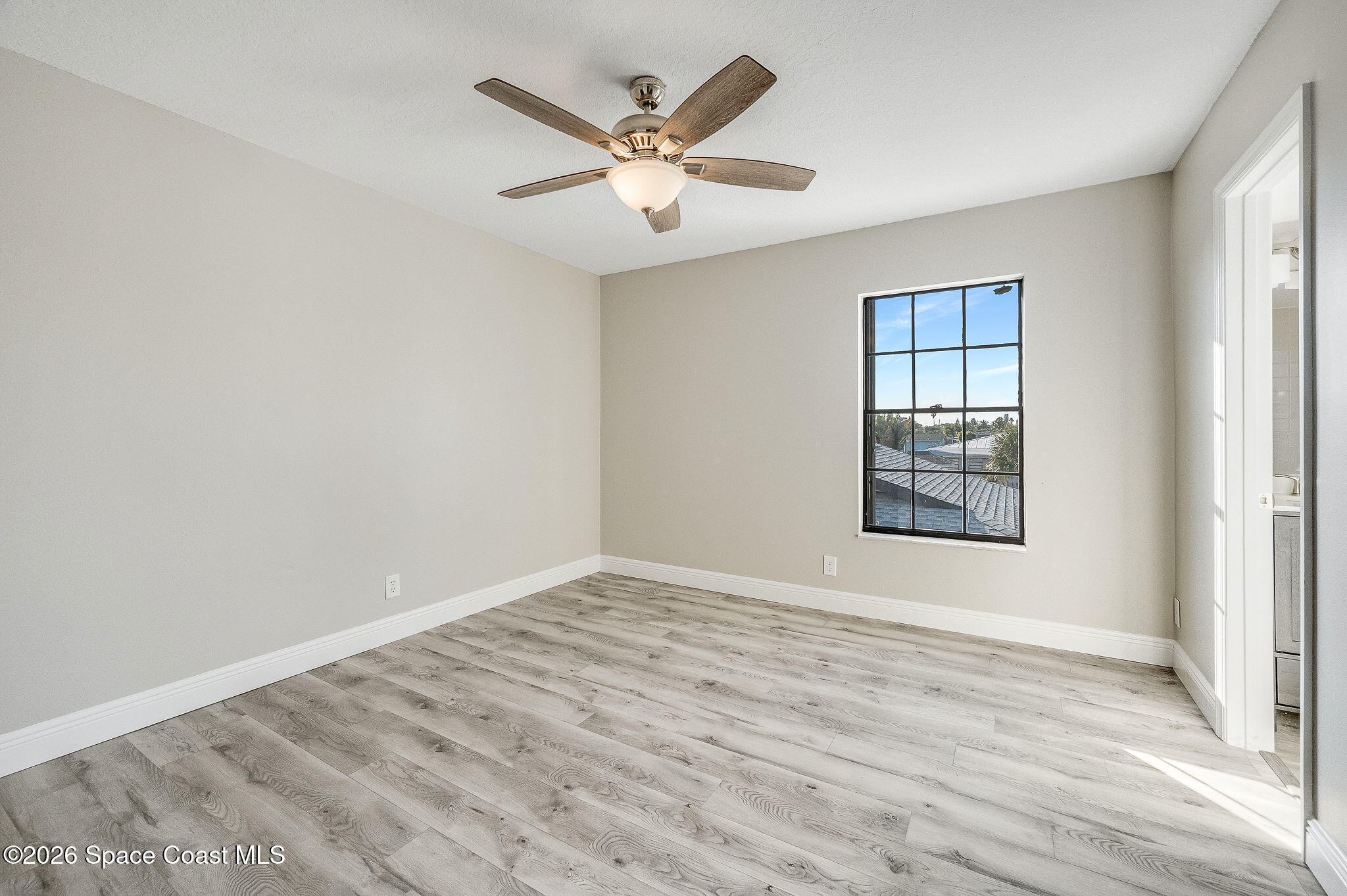 720 Palm Springs Circle Indian Harbour Beach, FL 32937 - Photo 33 of 57 wooden floor in an empty room with a window