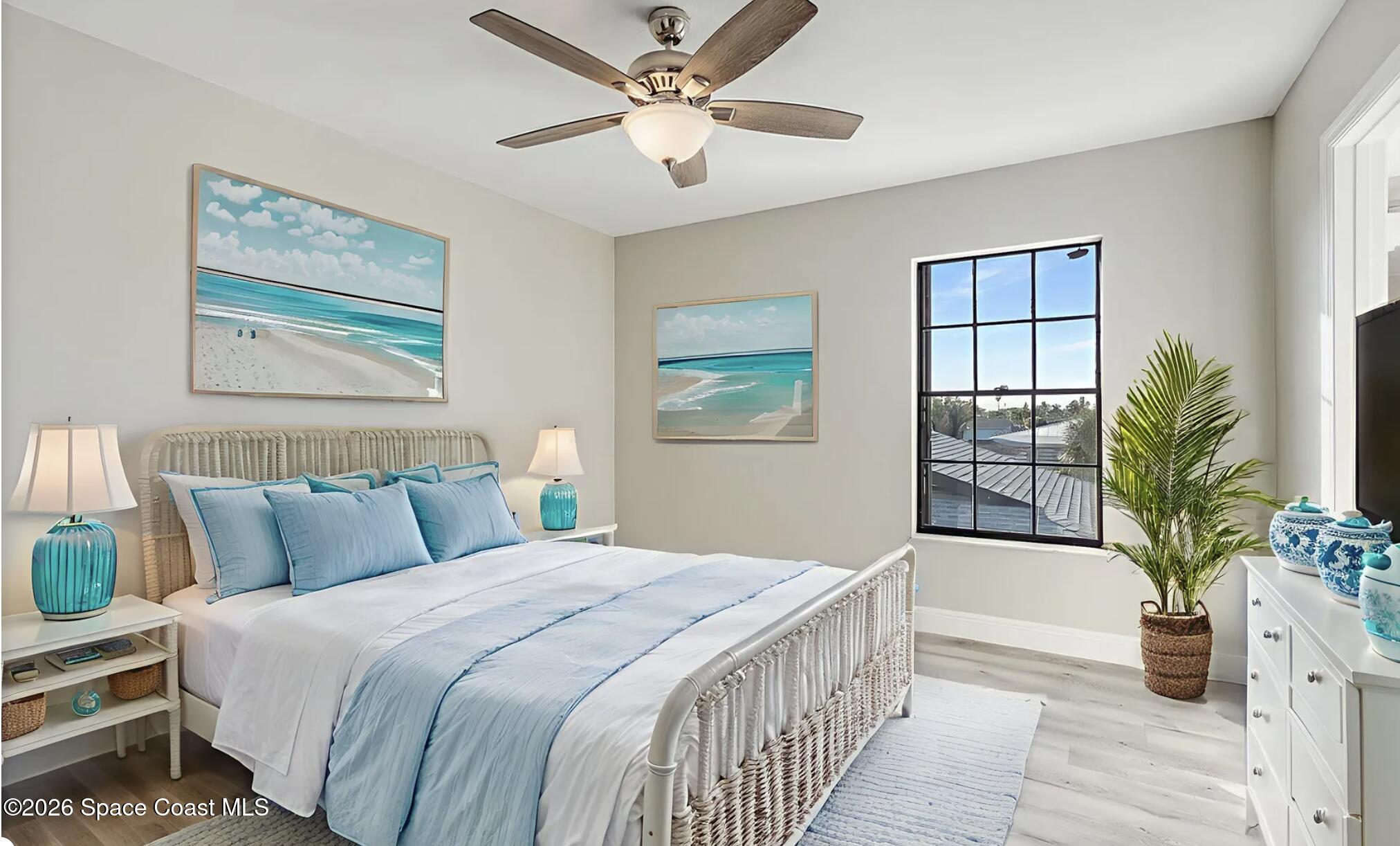 720 Palm Springs Circle Indian Harbour Beach, FL 32937 - Photo 34 of 57 a bedroom with a large bed and a chandelier