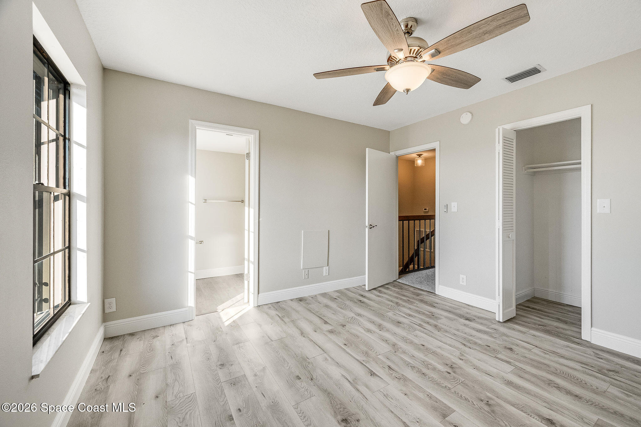 720 Palm Springs Circle Indian Harbour Beach, FL 32937 - Photo 35 of 57 a view of an empty room with window and wooden floor