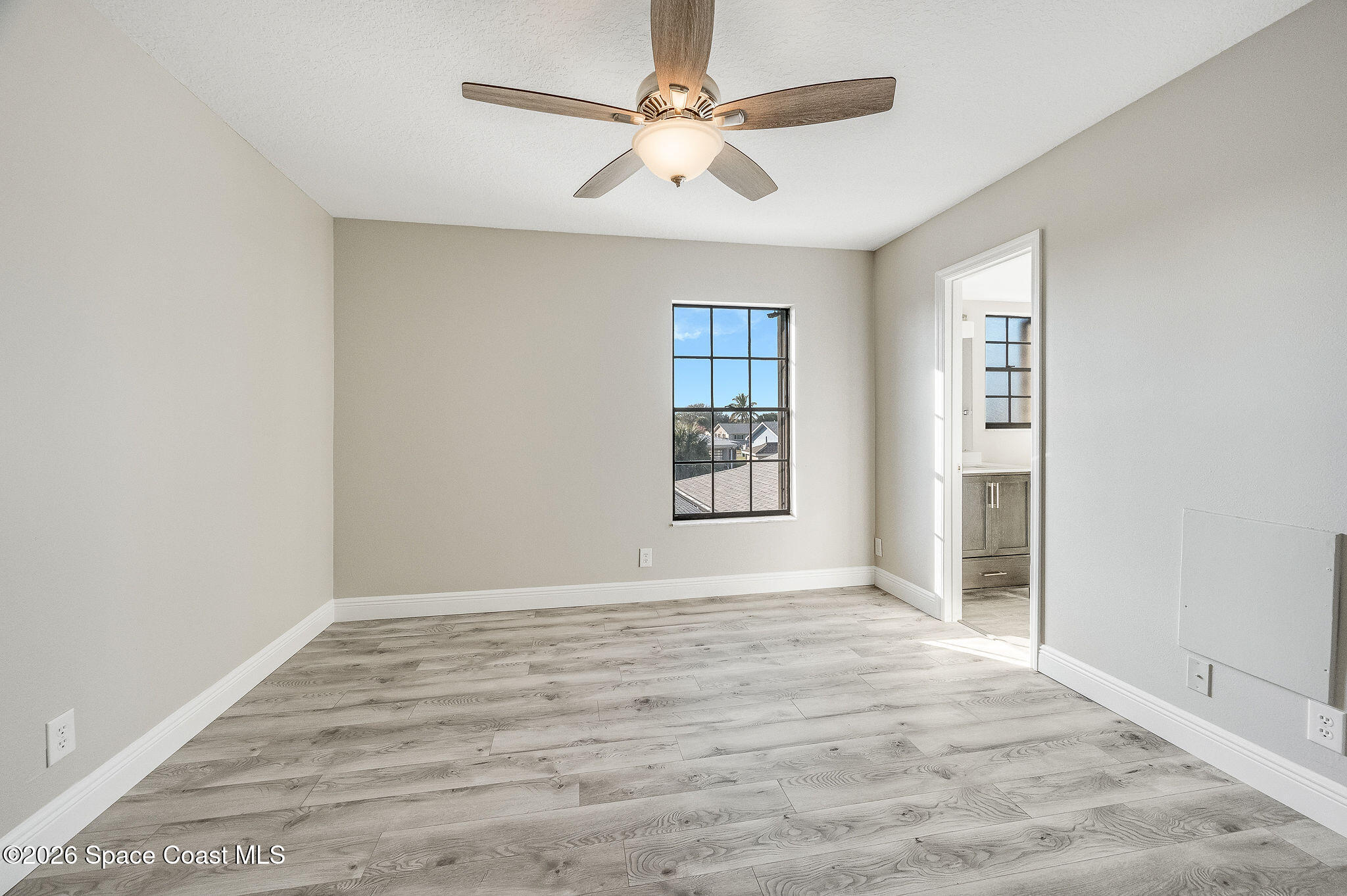 720 Palm Springs Circle Indian Harbour Beach, FL 32937 - Photo 36 of 57 wooden floor in an empty room with a window