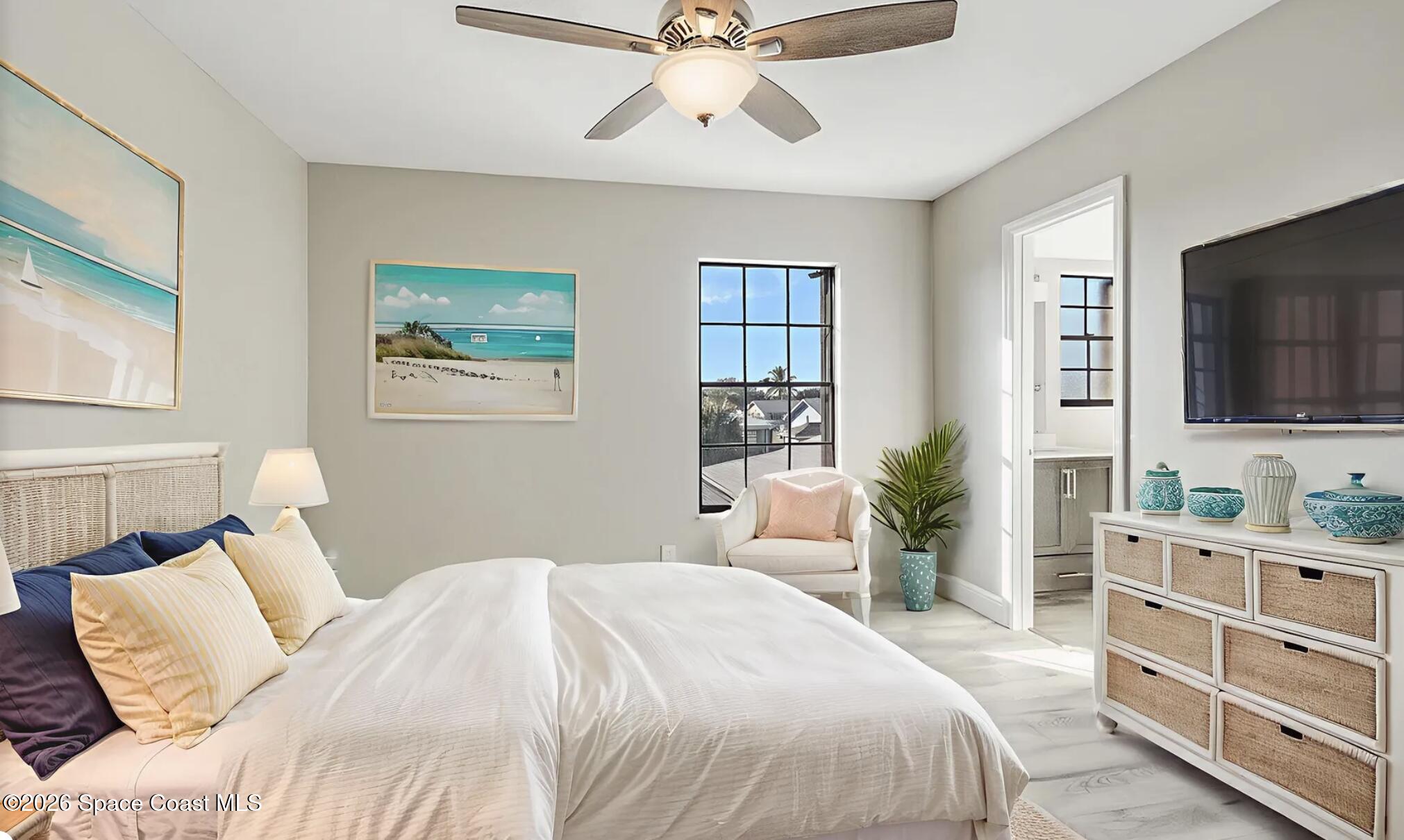 720 Palm Springs Circle Indian Harbour Beach, FL 32937 - Photo 37 of 57 a bedroom with a large bed and a flat screen tv