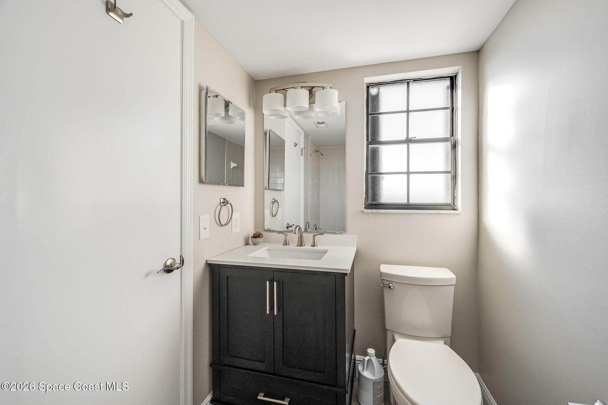 720 Palm Springs Circle Indian Harbour Beach, FL 32937 - Photo 43 of 57 a bathroom with a toilet a sink and mirror