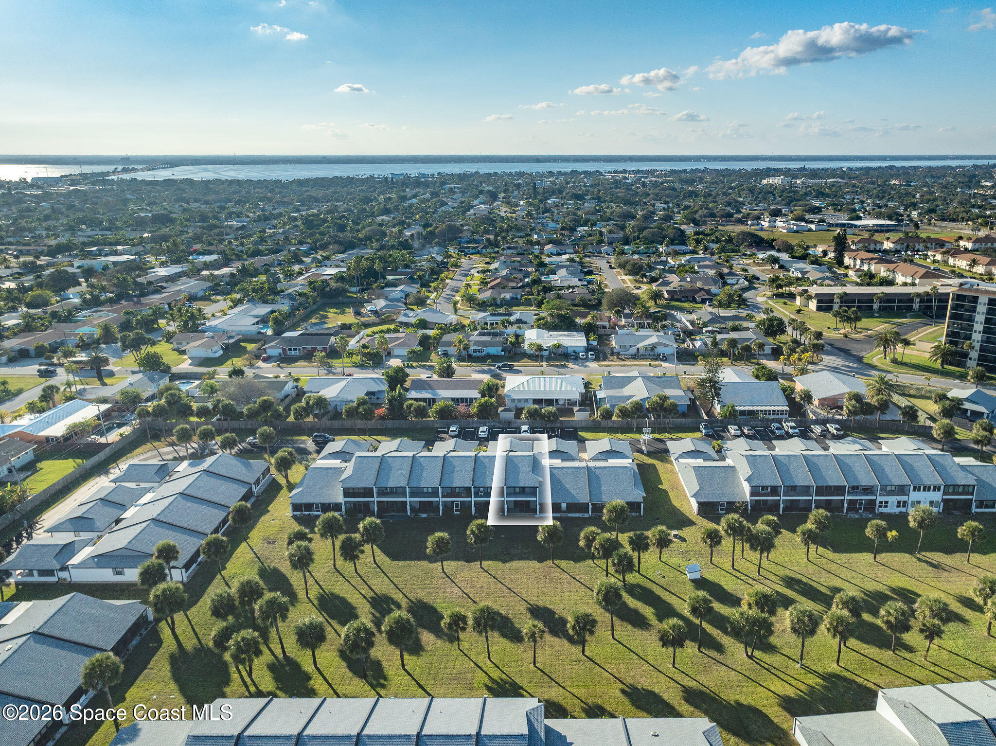 720 Palm Springs Circle Indian Harbour Beach, FL 32937 - Photo 57 of 57 an aerial view of a residential apartment building with a yard