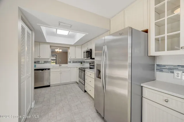 a kitchen with a refrigerator and window