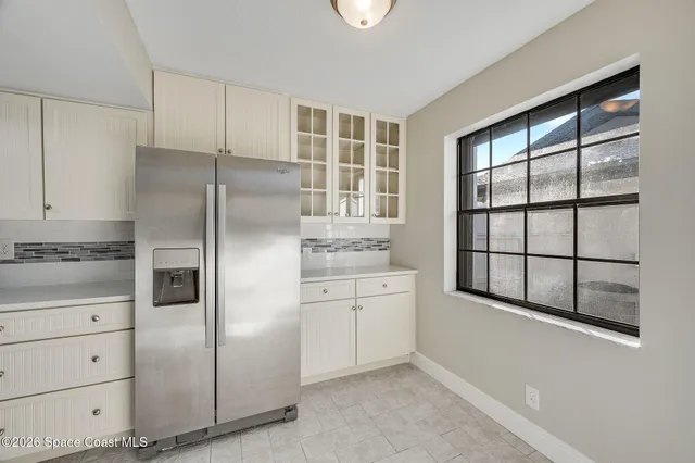 a view of kitchen with wooden floor and electronic appliances