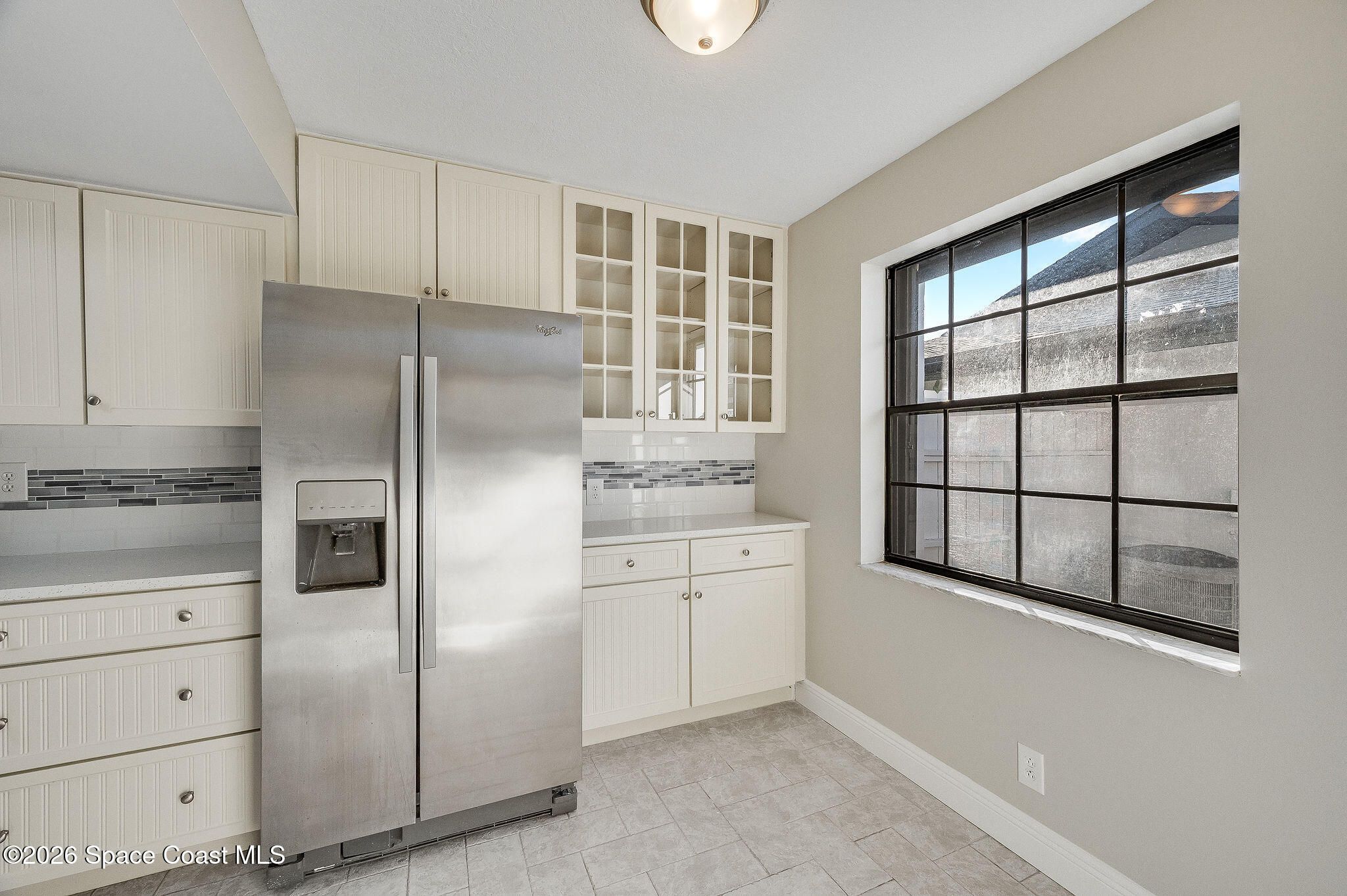 720 Palm Springs Circle Indian Harbour Beach, FL 32937 - Photo 10 of 57 a kitchen with a refrigerator and window