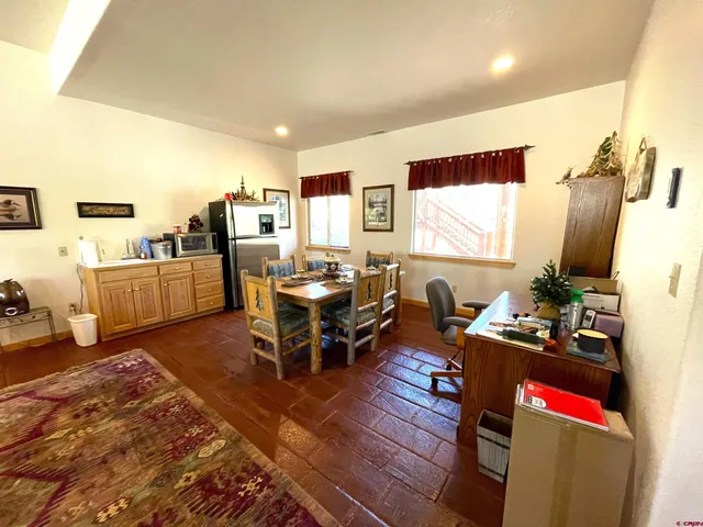 a dining room with furniture and window