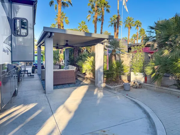 a view of a balcony with chair and potted plants