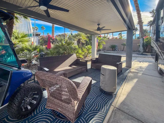 a view of a porch with furniture and a potted plant