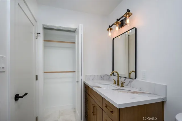a bathroom with a sink vanity and a mirror