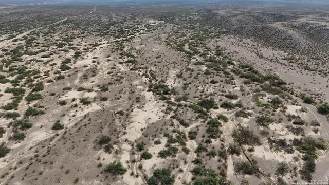 a view of a field with an ocean view