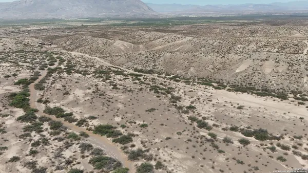 a view of a dry yard with wooden floor