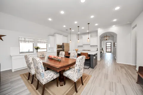a view of a dining room with furniture and wooden floor