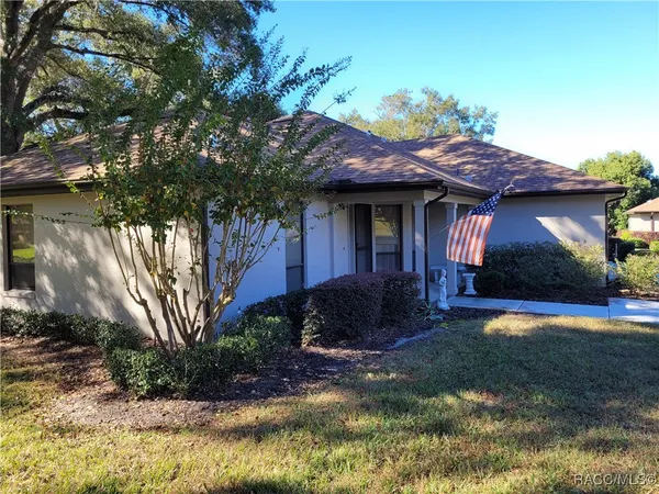 a view of a house with a yard and plants