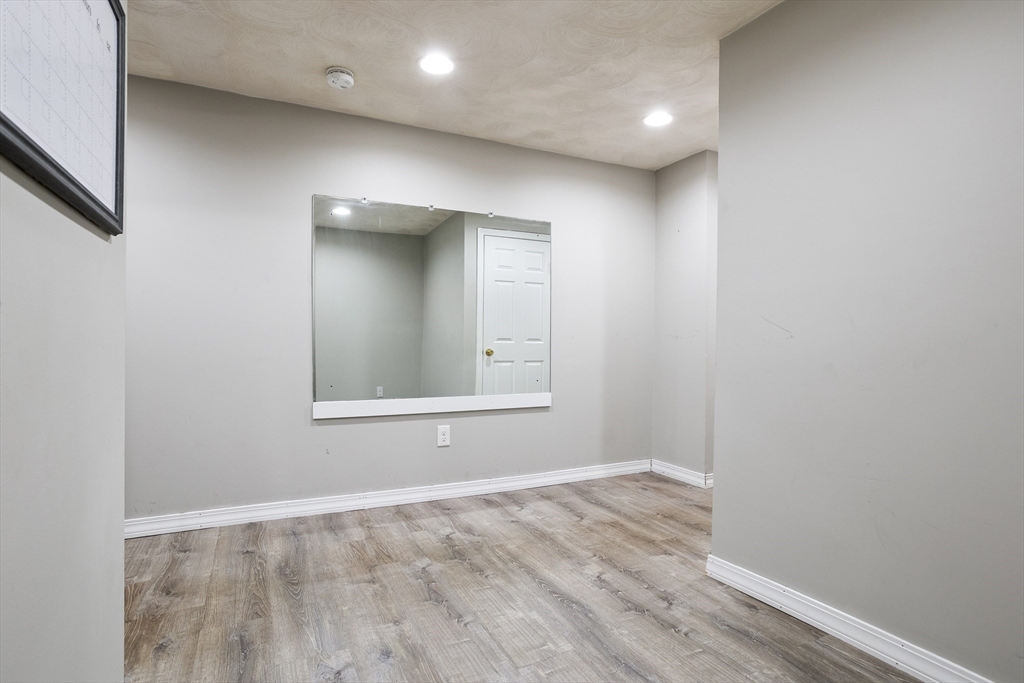 16 Middlesex Street, Unit 4 Chelmsford, MA 01863 - Photo 14 of 25 a view of an empty room with wooden floor and a window
