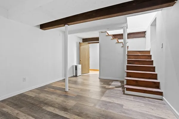 a view of a livingroom with wooden floor and closet